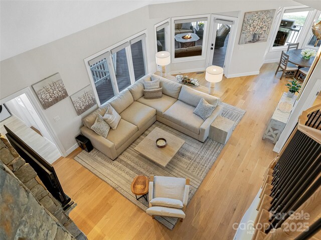 living area featuring baseboards and wood finished floors