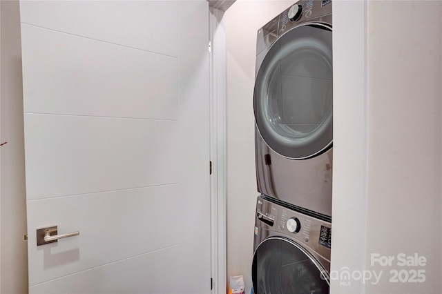 washroom with stacked washer / dryer and laundry area