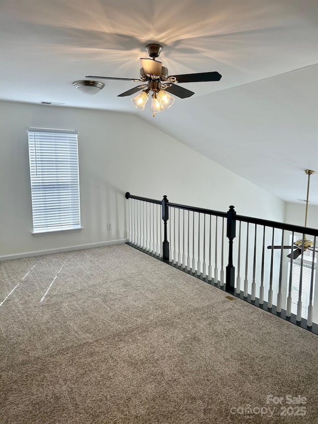 additional living space featuring lofted ceiling, a ceiling fan, baseboards, and carpet flooring