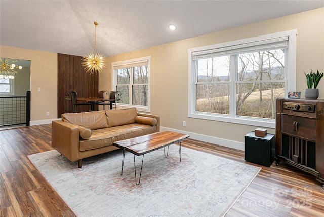 living room with a wealth of natural light and a notable chandelier