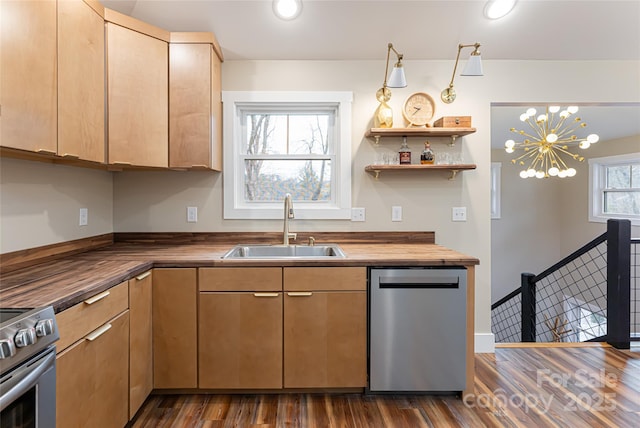 kitchen with butcher block counters, dark wood-style flooring, appliances with stainless steel finishes, and a sink