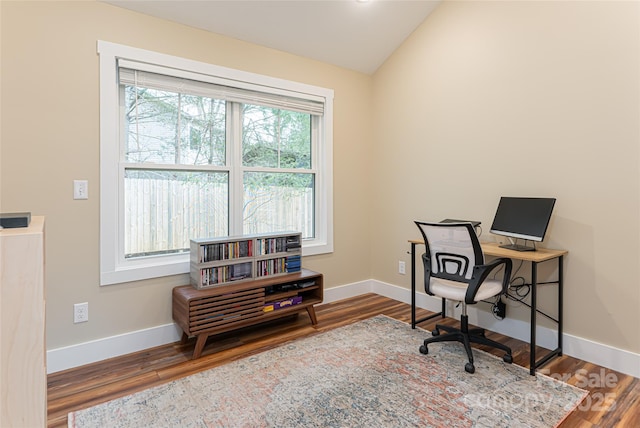 office area with wood finished floors, baseboards, and vaulted ceiling