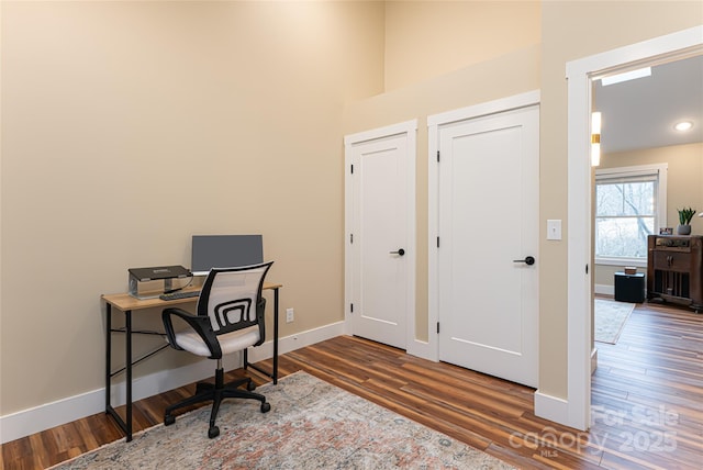 office area with baseboards and wood finished floors