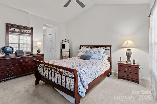 bedroom with a closet, ceiling fan, lofted ceiling, and carpet floors