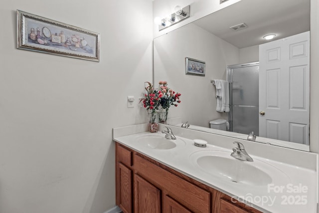 full bathroom with a sink, visible vents, a stall shower, and double vanity