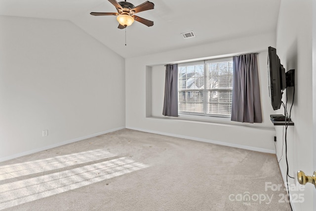 unfurnished room with visible vents, baseboards, carpet flooring, lofted ceiling, and ceiling fan