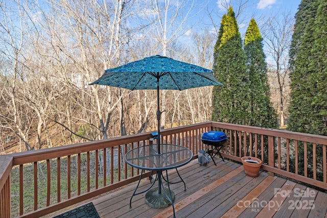 wooden terrace with area for grilling