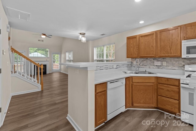2592 Brackley Pl NW, Concord, NC 28027 - kitchen with white appliances, a sink, healthy amount of natural light, dark wood finished floors, and recessed lighting