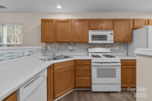 2592 Brackley Pl NW, Concord, NC 28027 - kitchen with white appliances, a sink, light countertops, dark wood-style flooring, and decorative backsplash