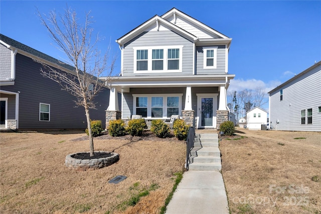 craftsman-style house featuring stone siding, covered porch, and central AC