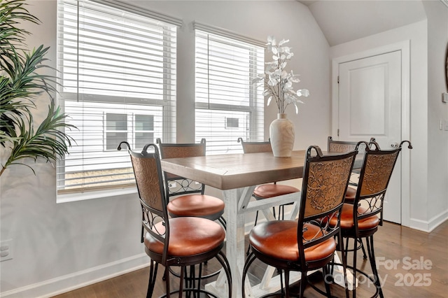 dining space with plenty of natural light, baseboards, and wood finished floors