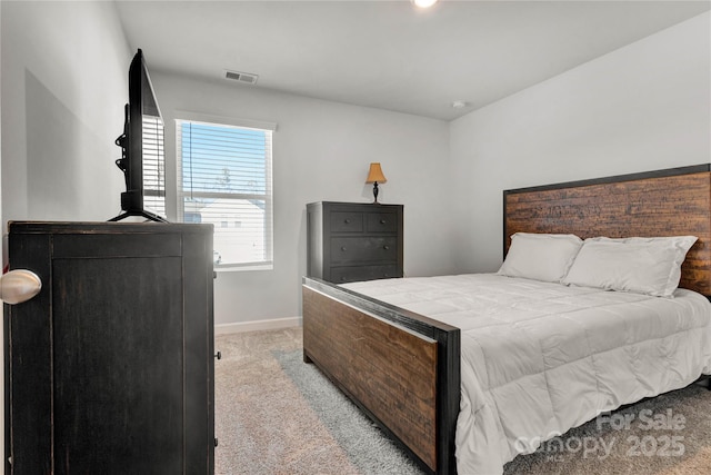 bedroom with baseboards, visible vents, and light colored carpet