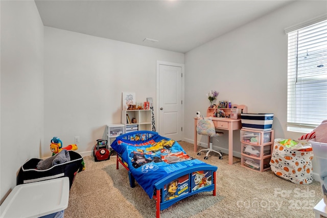 carpeted bedroom with baseboards