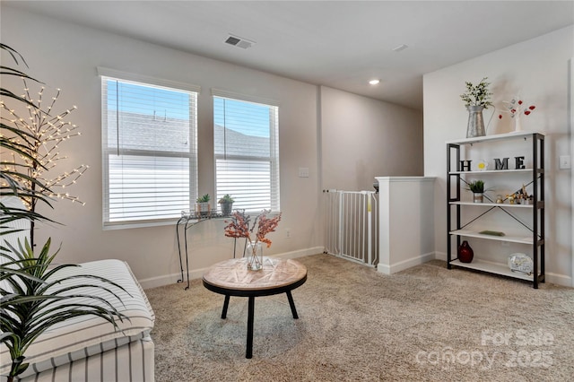 sitting room featuring carpet floors, visible vents, and baseboards