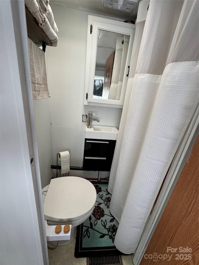 bathroom with toilet and vanity