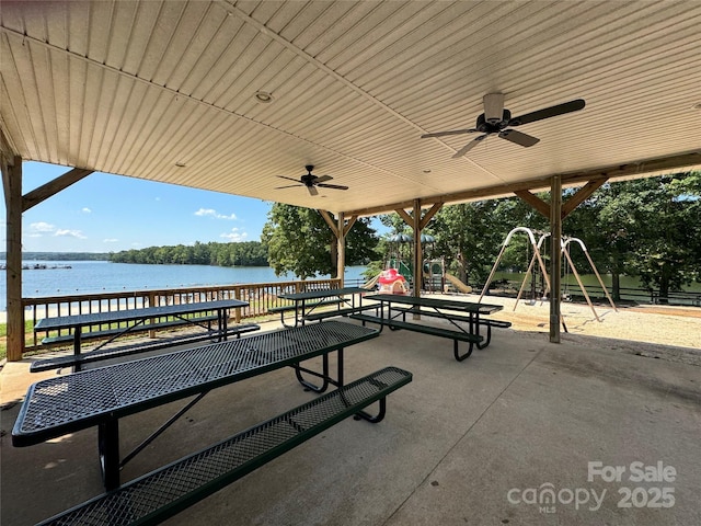 view of property's community with a water view and playground community
