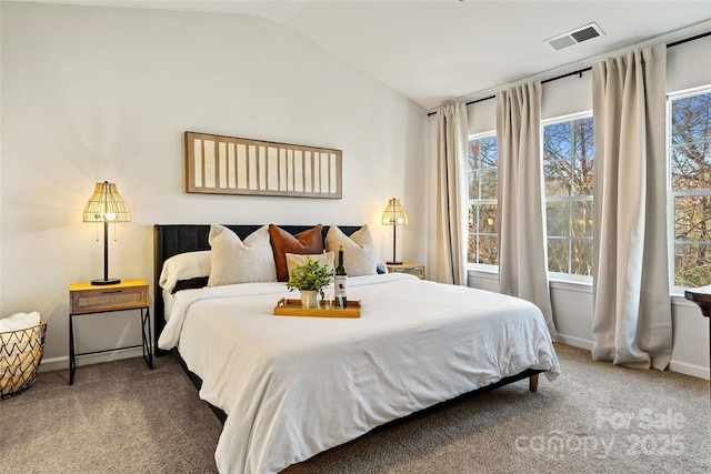 carpeted bedroom with visible vents, vaulted ceiling, and baseboards