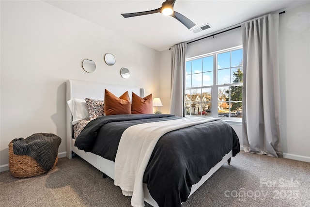 carpeted bedroom with ceiling fan, visible vents, and baseboards