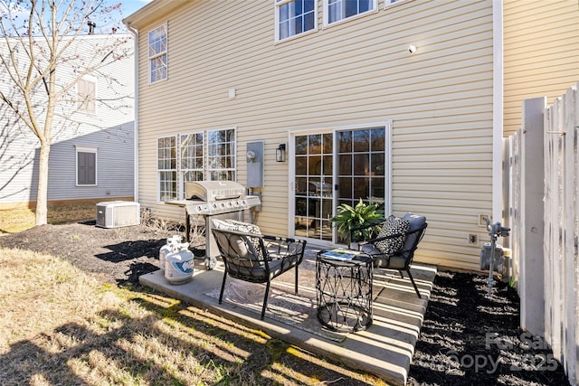 view of patio / terrace with central AC unit, grilling area, and fence