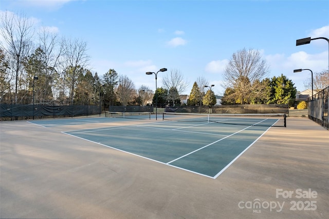 view of tennis court featuring fence