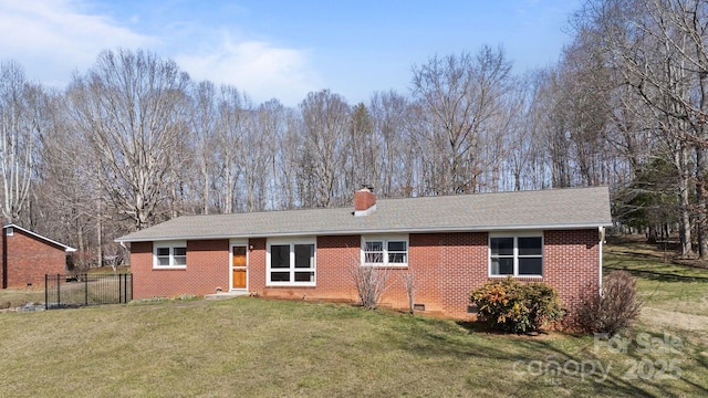 back of property featuring brick siding, crawl space, a chimney, and a lawn