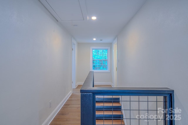 interior space featuring attic access, recessed lighting, baseboards, and wood finished floors