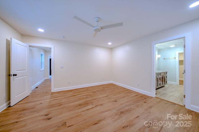 empty room with recessed lighting, light wood-style flooring, and baseboards