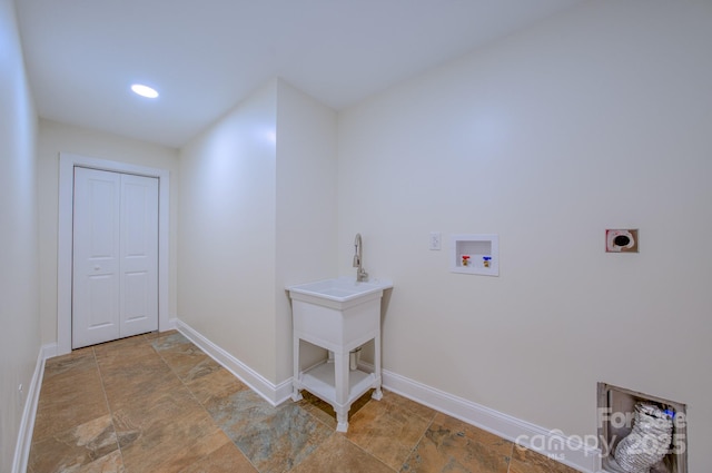 laundry room with hookup for a washing machine, stone finish flooring, electric dryer hookup, laundry area, and baseboards