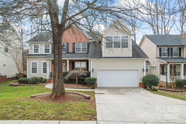 view of front of house featuring driveway, a garage, and a front yard