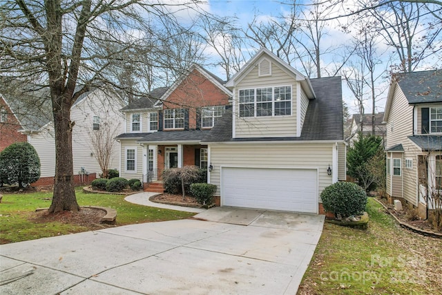 traditional-style house with a garage, concrete driveway, a shingled roof, and a front yard