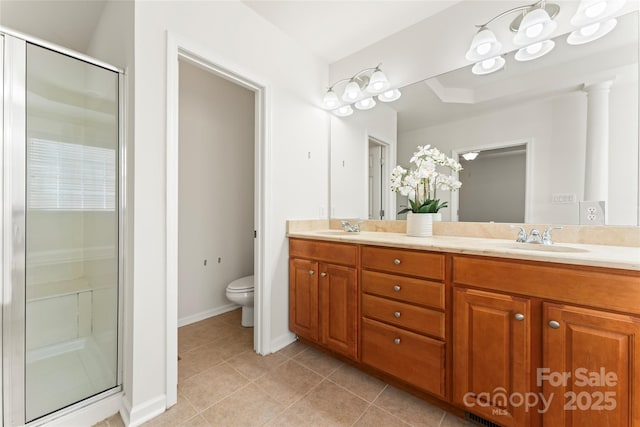 bathroom featuring a stall shower, tile patterned flooring, and a sink