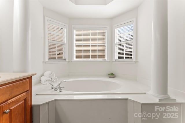 full bathroom featuring vanity and a bath