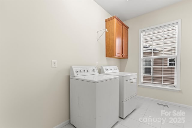 washroom with cabinet space, light tile patterned floors, baseboards, visible vents, and independent washer and dryer