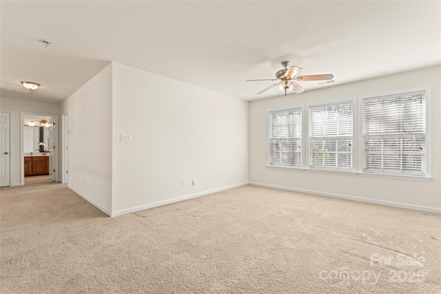 empty room with carpet floors, baseboards, and a ceiling fan