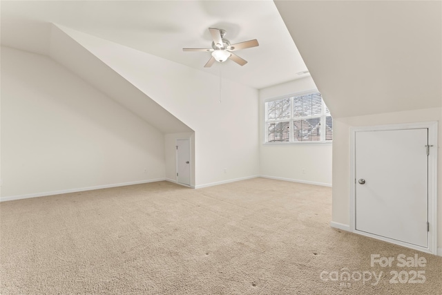 bonus room featuring vaulted ceiling, ceiling fan, baseboards, and light colored carpet