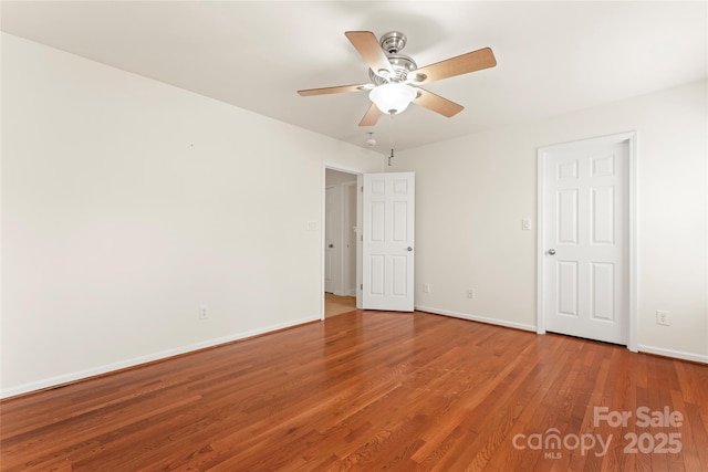 unfurnished bedroom featuring ceiling fan, baseboards, and wood finished floors