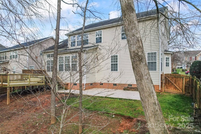 back of property featuring crawl space, a wooden deck, a gate, and fence