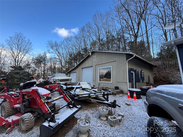 view of side of home featuring an outbuilding