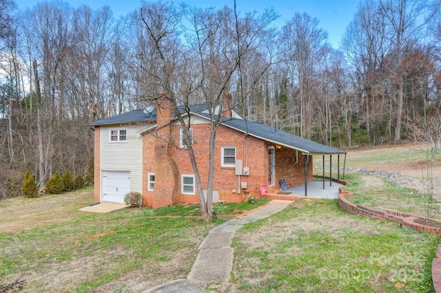 view of front of property featuring a front lawn, brick siding, a chimney, and an attached garage