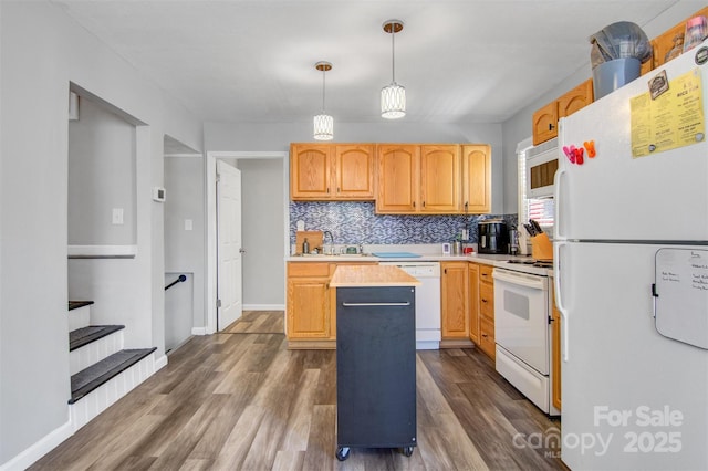 kitchen with white appliances, tasteful backsplash, dark wood-type flooring, decorative light fixtures, and light countertops