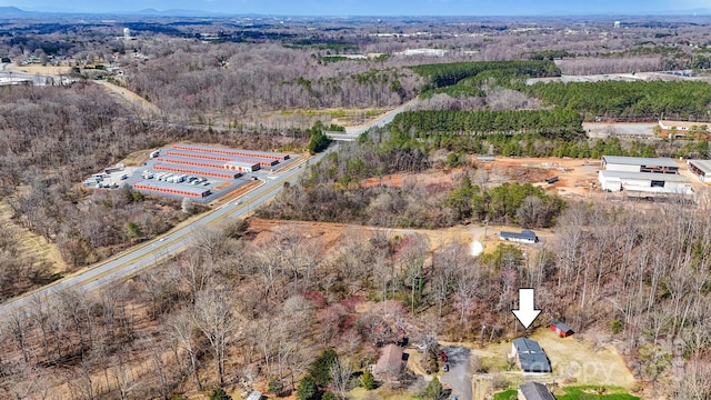 birds eye view of property with a wooded view