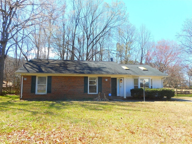 single story home with brick siding and a front lawn