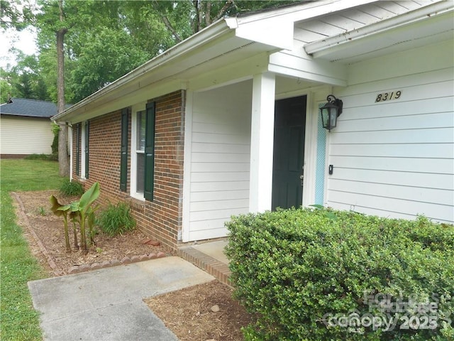 entrance to property with brick siding