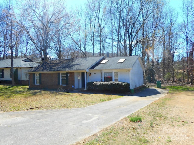 single story home with brick siding and a front lawn