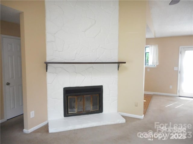 interior details featuring carpet floors, a fireplace, and baseboards