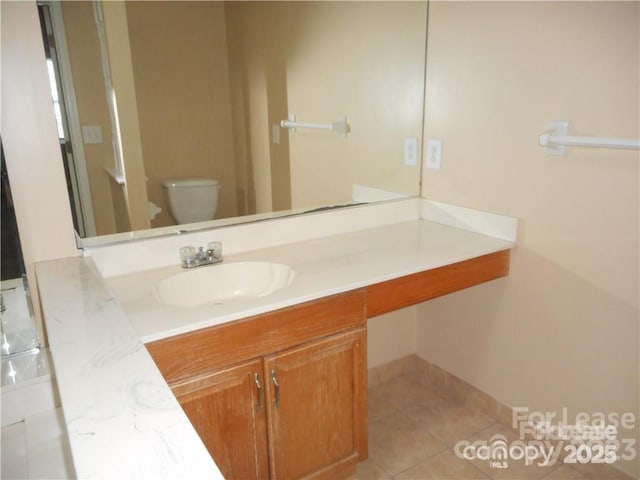 bathroom featuring vanity, toilet, and tile patterned floors