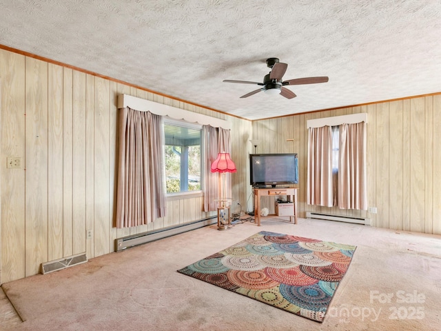 living room with visible vents, a textured ceiling, and baseboard heating