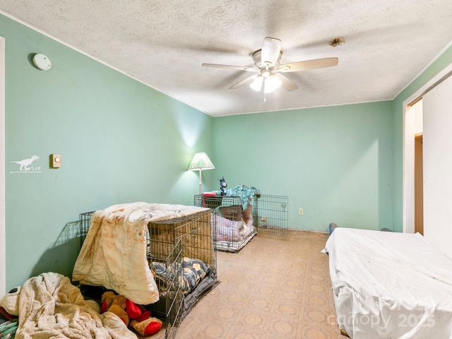 bedroom with a textured ceiling and a ceiling fan