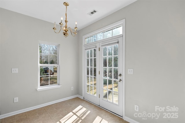 entryway featuring a notable chandelier, visible vents, and baseboards