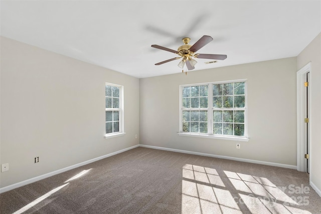 carpeted spare room with baseboards and ceiling fan